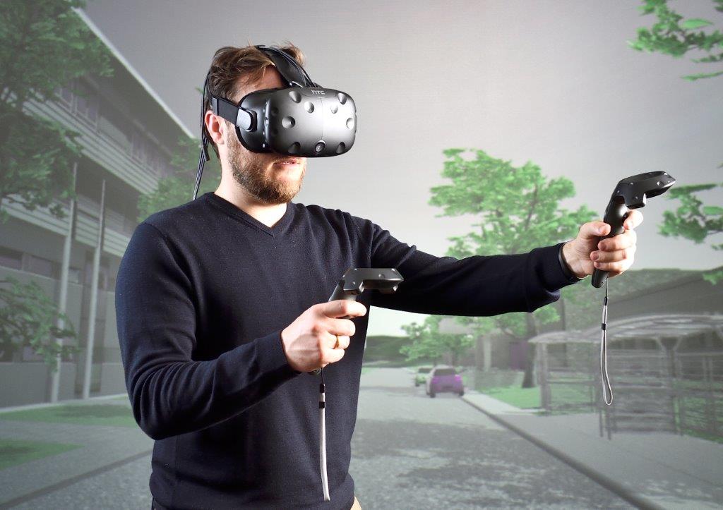 Person with head mounted display in front of a backprojection wall